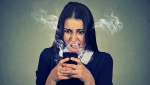 angry woman at robocalls and robotexts